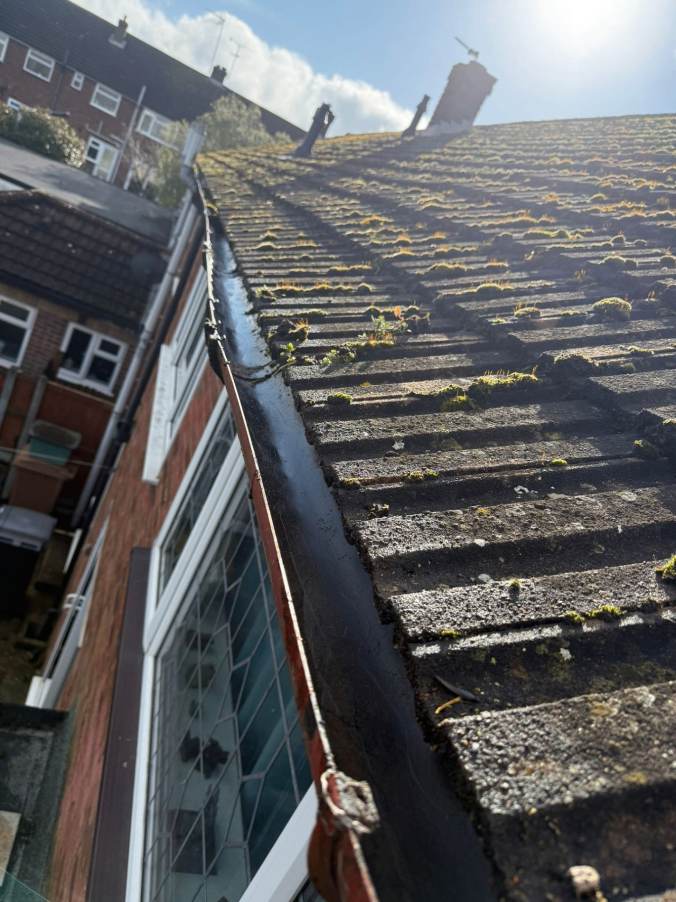 Same roofline close-up after moss and grass removal